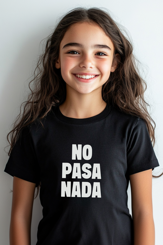 A smiling young girl wearing a black T-shirt with “NO PASA NADA” in bold white letters. This unisex design works for both boys and girls, with a baby tee fit option for women, offering a casual Spanish-inspired style.
