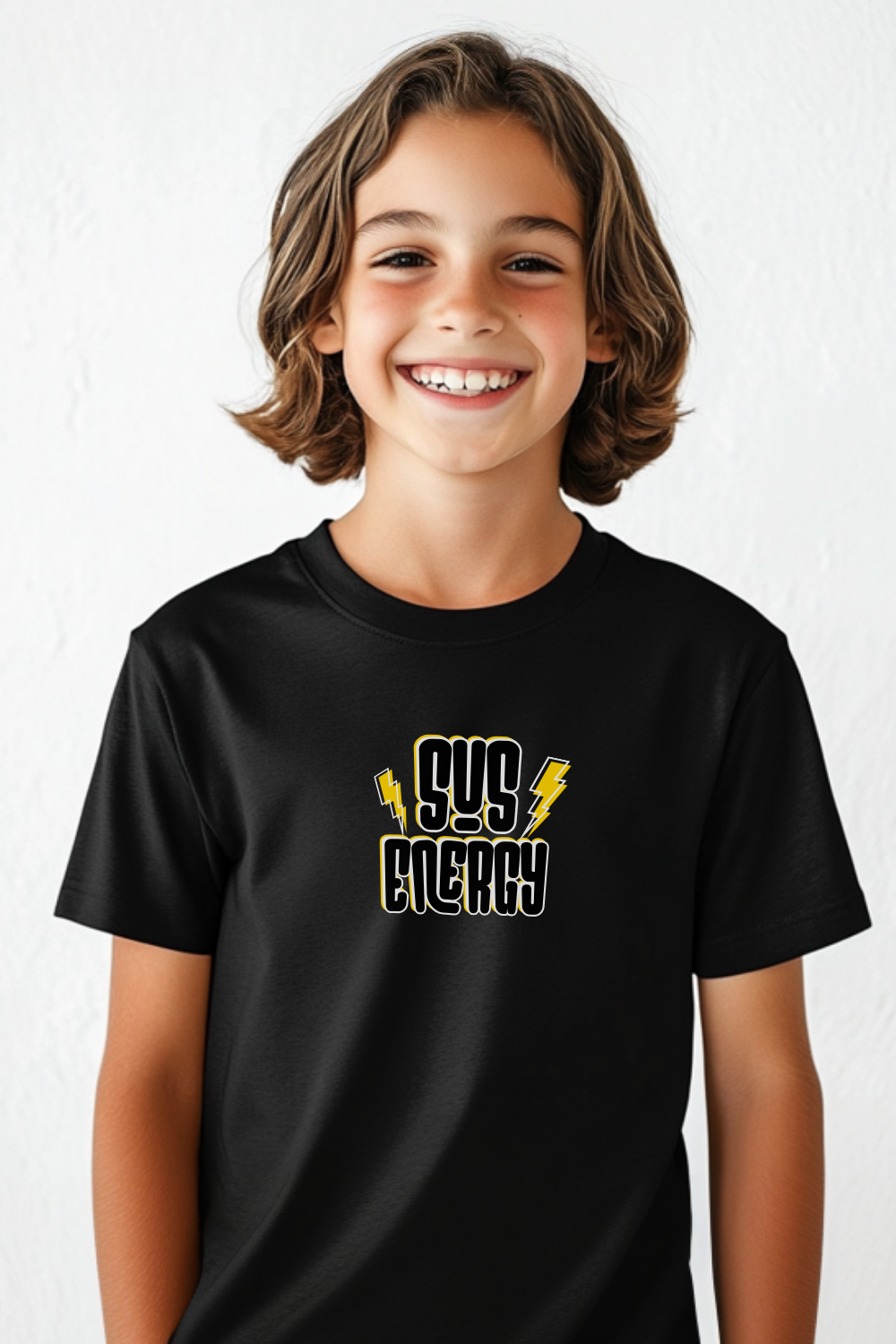 Smiling child wearing a black Comfort Colors youth t-shirt with a bold "SUS ENERGY" graphic design featuring stylized block letters and yellow lightning bolts. Trendy unisex kids' graphic tee with a fun, modern aesthetic.