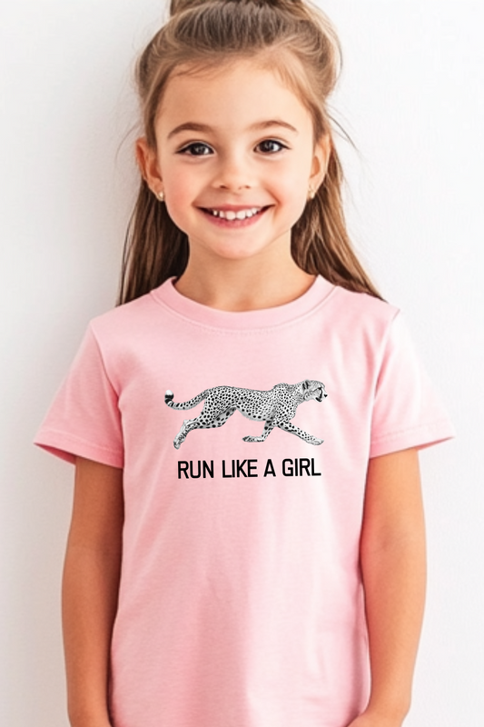 Young girl wearing a light pink t-shirt with a bold white cheetah graphic and the empowering phrase "RUN LIKE A GIRL." This image highlights inspiring kids' fashion and an active, confident lifestyle, perfect for parents looking for trendy and motivational children's clothing.