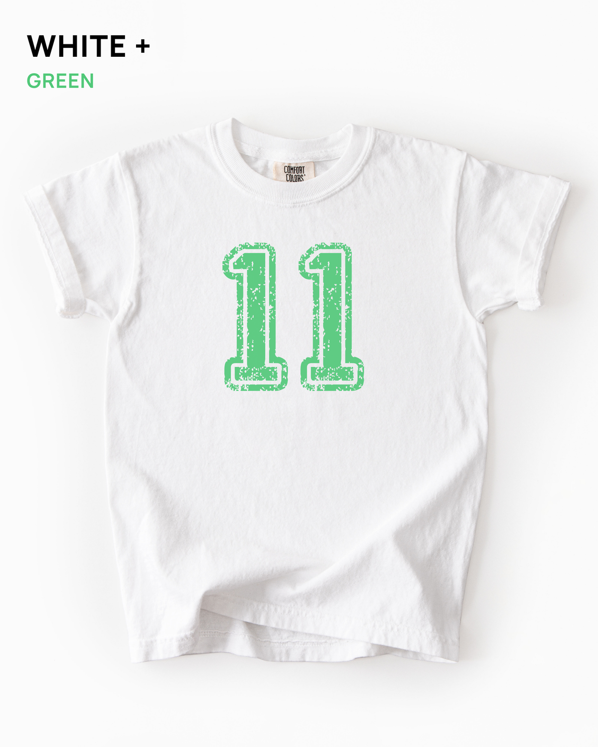 Custom varsity number tee in White with a green distressed varsity number